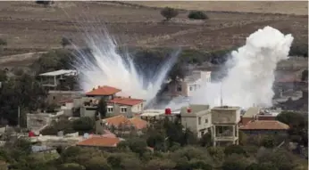  ?? ARIEL SCHALIT/THE ASSOCIATED PRESS ?? Smoke rises after shells fired by the Syrian army explode in the Syrian village of Bariqa on Tuesday.