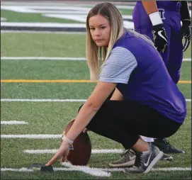  ?? COURTESY PHOTO/ KRISTINA LEWIS ?? Above: Tokay assistant coach Bailey Smith works with Tokay's kickers during a game in 2018. Right: Wearing a wrist band that says “courage”, Tokay High kicker Bailey Smith hydrates herself during a 2012 game against the Bear Creek Bruins at The Grape Bowl.