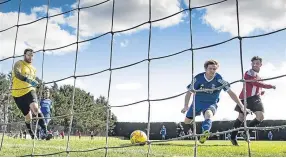  ??  ?? Steve Martin (red and white stripes) can’t contain his smile as he slots in Dundee Argyle’s fourth and final goal against Tayport.