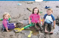  ??  ?? Having a great time at last year’s beach sculpture competitio­n at Whiting Bay was Isla and Ava Pringle who joined their friend Innes West to play in the water. 01_B30beach14