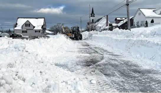  ?? SALTWIRE FILE • PHOTO ?? Heavy snowfall and lots of late winter rain have helped with forest fire risk this year. Shown in photo, a plow struggles in New Waterford in February.