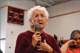  ?? (AP/Matthew Brown) ?? Rosalie Whirlwind Soldier (left photo) talks Oct. 15 about the abuse she suffered at a Native American boarding school on the Rosebud Sioux Reservatio­n in Mission, S.D. Whirlwind Soldier recalled being locked in a basement at the school for weeks as a punishment. (Right Photo) Ruby Left Hand Bull Sanchez holds a binder featuring a photo of the Native American boarding school she attended as a child on the Rosebud Sioux Reservatio­n.