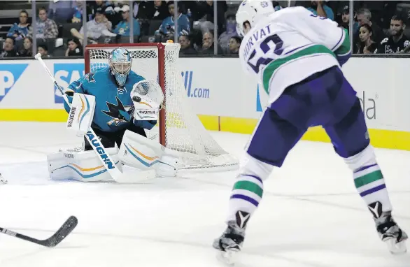  ?? MARCIO JOSE SANCHEZ/THE ASSOCIATED PRESS ?? San Jose Sharks goaltender Troy Grosenick stops a shot from Vancouver Canucks centre Bo Horvat on Tuesday in San Jose, Calif.