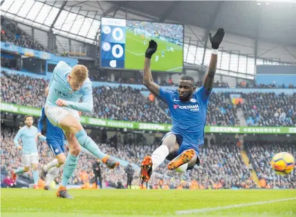  ?? Picture / AP ?? Manchester City’s Kevin De Bruyne lets fly ahead of Chelsea defender Antonio Rudiger.