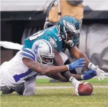  ?? MICHAEL PEREZ/ASSOCIATED PRESS ?? Philadelph­ia’s Kenjon Barner, right, and Dallas’ Lance Lenoir chase a loose punt during Sunday’s game. The Cowboys won 6-0 and finished the season 9-7.