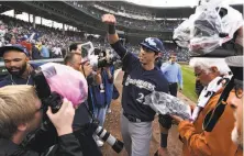  ?? Matt Marton / Associated Press ?? Outfielder Christian Yelich celebrates after the Brewers beat the Cubs 3-1 at Wrigley Field to earn the NL Central title.