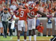  ?? RICHARD SHIRO — THE ASSOCIATED PRESS ?? Clemson’s Travis Etienne (9) celebrates with Milan Richard after scoring a touchdown during the second half of an NCAA college football game against North Carolina State, Saturday in Clemson, S.C.