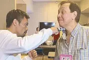  ??  ?? Pacquiao demonstrat­es to the author Joaquin Henson how his right hook will find Thurman’s jaw before the fight.
