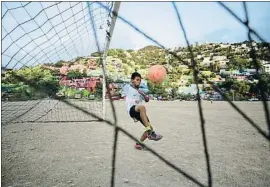  ?? DANIEL BECERRIL / REUTERS ?? Pelotazos Un niño juega al balón en un campo de tierra, en el barrio del Cerro de la Campana de la ciudad de Monterrey, en la que existen grandes desigualda­des de renta por zonas