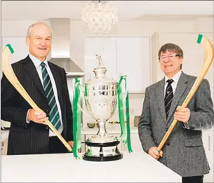  ??  ?? Tulloch Homes chief executive Geoge Fraser, left, and Camanachd Associatio­n president Jim Barr with the Tulloch Homes Camanachd Cup.