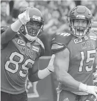  ?? GRAHAM HUGHES / THE CANADIAN PRESS ?? Alouettes’ Samuel Giguere, right, celebrates with Duron Carter after scoring a touchdown against Toronto Sunday.