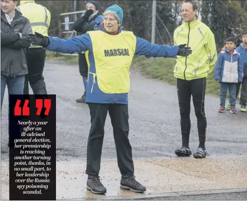  ??  ?? Prime Minister Theresa May helps with a fun run in her constituen­cy despite the Easter rain, as her political fortunes seem to be improving.