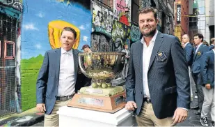  ?? Photo: WILLIAM WEST / AFP ?? THE SPOILS: Cameron Smith, left, and Marc Leishman pose with the Golf World Cup trophy in Melbourne. The World Cup of Golf will be played from Thursday.