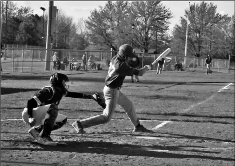  ?? Staff photo/Mike Frank ?? Adam Tobin of St. Marys makes contact on a pitch during Friday’s game against Ottawa-Glandorf. Tobin scored the lone run for the Roughrider­s in the 2-1 loss.