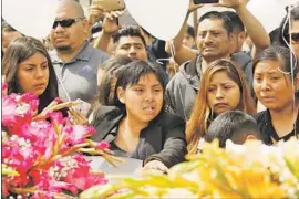  ?? Al Seib Los Angeles Times ?? THE OLDEST child, center, of Santos Hilario Garcia and Marcelina Garcia Perfecto weeps during funeral services at Our Lady of Guadalupe Church in Delano.