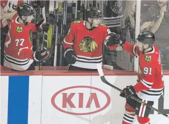  ?? PAUL BEATY/AP ?? Caggiula (91) celebrates with Patrick Kane and Kirby Dach (77) during the regular season.