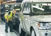  ?? (Darren Staples/Reuters) ?? A WORKER INSPECTS a Land Rover on the production line at a factory in Solihull, central England, in 2012. Thanks to a weaker pound, factory production in the UK has not slowed since June’s Brexit vote.