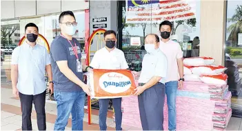  ??  ?? Chan (right) presenting the items to Tawau hospital, received by Pang and witnessed by Liew and his team.