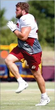  ?? AP PHOTO BY STEVE HELBER ?? Washington Redskins offensive guard Wes Martin (78) does a warm up drill during the Washington Redskins NFL football training camp in Richmond, Va., Wednesday, July 31. Redskins rookie guard Wes Martin isn’t just a strong NFL prospect who built his strength growing up on a dairy farm. He started a dog rescue foundation and raised money for it at his pre-draft pro day.