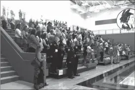  ??  ?? Above: Friends and community gathered in the gym at Lakeview-Fort Oglethorpe High School to honor Randall Smith’s service to his country. Right: Veterans do a presentati­on of The Missing Man Table at a ceremony honoring Randall Smith. (Staff photos)