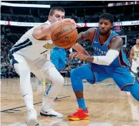  ?? AP ?? Denver Nuggets’ Nikola Jokic (left) reaches out for a loose ball as Thunder’s Paul George defends. —