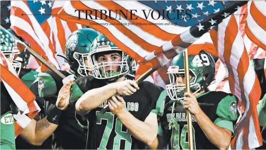  ?? JOHN SMIERCIAK/POST TRIBUNE ?? Valparaiso High School’s Carter Finucane waves a flag before the game against Chesterton High School on Sept. 18 in Valparaiso, Indiana.