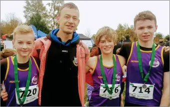  ??  ?? Leinster Under-14 cross-country champion Aidan Shannon, head coach Ted Flannelly, Myles Hewlett (second) and Darragh Flannelly (seventh), all from United Striders A.C.