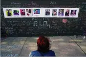  ?? MATT ROURKE — THE ASSOCIATED PRESS FILE ?? A person visits a makeshift memorial near the scene of a shooting at a supermarke­t in Buffalo.