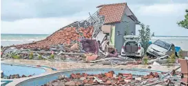  ?? [AP PHOTO] ?? Debris litters a property badly damaged by a tsunami Sunday in Carita, Indonesia.