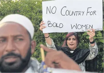  ?? AFP ?? A Pakistani civil society activist carries a placard during a protest in Islamabad on Monday against the murder of social media celebrity Qandeel Baloch by her own brother.