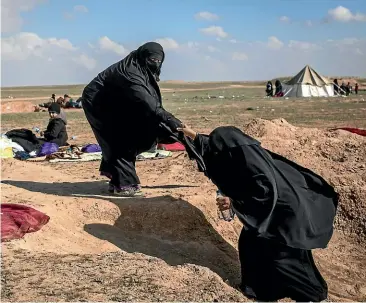  ?? GETTY IMAGES ?? Civilians who have fled fighting in Baghuz wait to board trucks after being screened by members of the Syrian Democratic Forces (SDF) at a makeshift screening point in the desert.