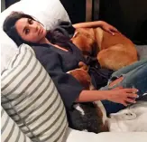  ??  ?? My buddies: Meghan cuddles her beloved rescue dogs Guy and Bogart