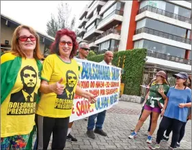  ??  ?? Supporters of Brazil’s President-Elect, Jair Bolsonaro wait outside Bolsonaro’s condominiu­m at Barra da Tijuca neighbourh­ood in Rio de Janeiro, Brazil on Thursday. REUTERS