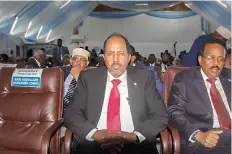  ?? AP Photo/Farah Abdi Warsameh ?? Presidenti­al candidates, former President Hassan Sheikh Mohamud, center, and incumbent leader Mohamed Abdullahi Mohamed, right, attend a voting session Sunday for the presidenti­al election at the Halane military camp, which is protected by African Union peacekeepe­rs, in Mogadishu, Somalia. Legislator­s in Somalia are meeting to elect the country’s president in the capital, Mogadishu, which is under lockdown measures aimed at preventing deadly militant attacks.