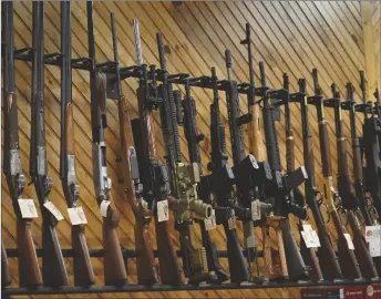  ?? AP PHOTO/ROBERT F. BUKATY, ?? Various guns are displayed at a store in Auburn, Maine, in 2022.