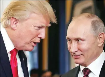  ?? MIKHAIL KLIMENTYEV/SPUTNIK/AFP ?? President Donald Trump (left) talks to Russia’s President Vladimir Putin as they attend the APEC Summit in the central Vietnamese city of Danang on November 11.