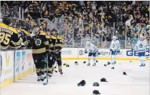  ?? WINSLOW TOWNSON THE ASSOCIATED PRESS ?? Hats litter the ice after David Pastrnak’s third goal Saturday. The Bruins sniper added three assists in a 7-3 whipping of the Leafs in Boston.