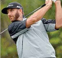  ?? AP ?? Eyes on the prize: Johnson hits an iron off the fourth tee