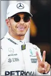  ??  ?? Pole position winner Mercedes’ British driver Lewis Hamilton celebrates after the qualifying session for the Formula One Azerbaijan Grand Prix at the Baku City Circuit
in Baku on June 24. (AFP)