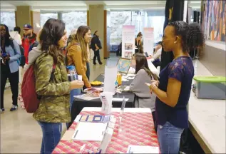  ?? Herald photo by J.W. Schnarr ?? Camila Agurto speaks with Rudeen Laina, Community Health Facilitato­r and volunteer co-ordinator for the Interfaith Food Bank, during the UVolunteer Fair at the University of Lethbridge on Wednesday. @JWSchnarr Herald