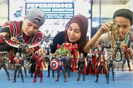  ??  ?? Marvel-lous collection: Visitors admiring the various figurines on display at the Superheroe­s Collection Exhibition at Mydin Mall in Bukit Mertajam.