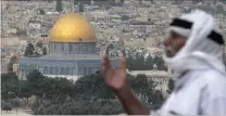  ?? Picture: EPA ?? A Muslim man poses for tourists pictures at the Mount of Olives promenade overlookin­g the Muslims’ holy site Haram al-Sharif, known as the Temple Mount to Jews, in Jerusalem.