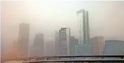  ?? | AFP ?? A VIEW of the skyline in Saudi Arabia’s capital Riyadh during a dust storm yesterday.