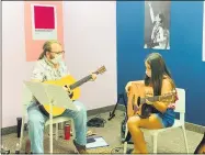  ?? SUBMITTED BY JACLYN BRADLEY ?? Guitar teacher Wesley Crow instructs student Sammie Masters, 9, at the Lorain Rock Town Music Academy, 401Broadwa­y. The academy began lessons the week of July 6with instructor­s and students taking appropriat­e precaution­s to avoid the spread of the novel coronaviru­s.