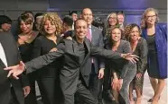  ?? Dan Haar/Hearst Connecticu­t Media ?? Shawn Wooden, center, hams it up with friends including U.S. House Minority Leader Hakeem Jeffries, D-NY, behind Wooden, at a gala in Wooden's honor Friday at Dunkin' Donuts Park in Hartford.