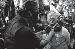  ?? VINCENT YU/AP ?? Richard Chan, a candidate for district council elections, Saturday in Hong Kong. Police fired tear gas and used a water cannon against protesters demanding meaningful autonomy after Beijing signaled it could tighten its grip on the territory.