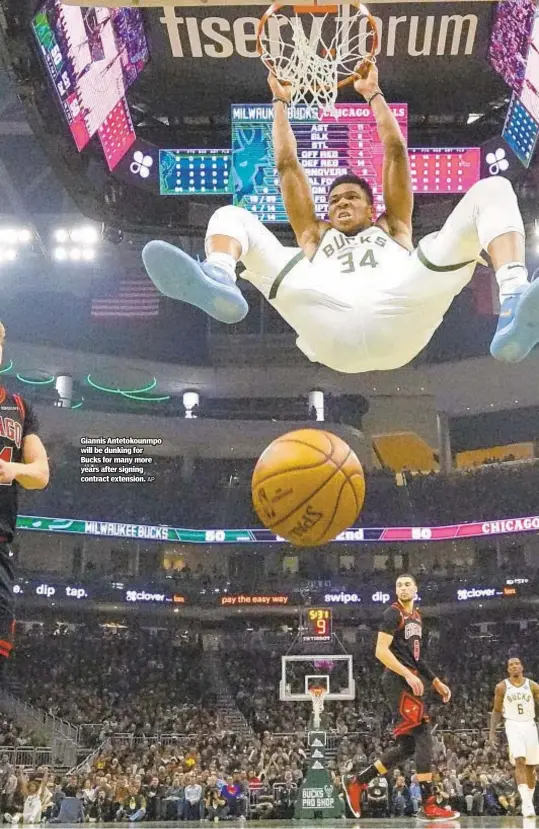  ??  ?? Giannis Antetokoun­mpo will be dunking for Bucks for many more years after signing contract extension.