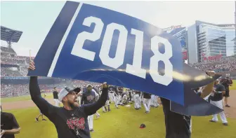  ?? AP PHOTO ?? FlaGGinG FOrtUnEs: atlanta center fielder Ender inciarte celebrates with teammates after the Braves beat the Phillies to clinch the nl East yesterday.