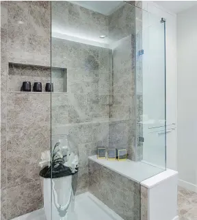  ??  ?? Spa-like showers are fitted with bench seating and built-in niches.