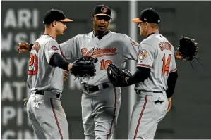  ??  ?? Baltimore fielder Adam Jones, centre, was racially abused.